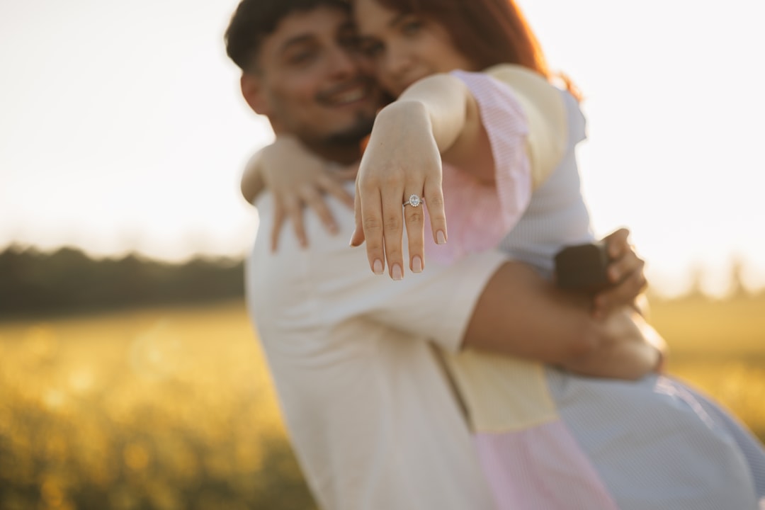 A man holding a woman in a field